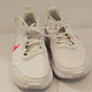 Nike White and Pink Athletic Shoes with Minimalist Design